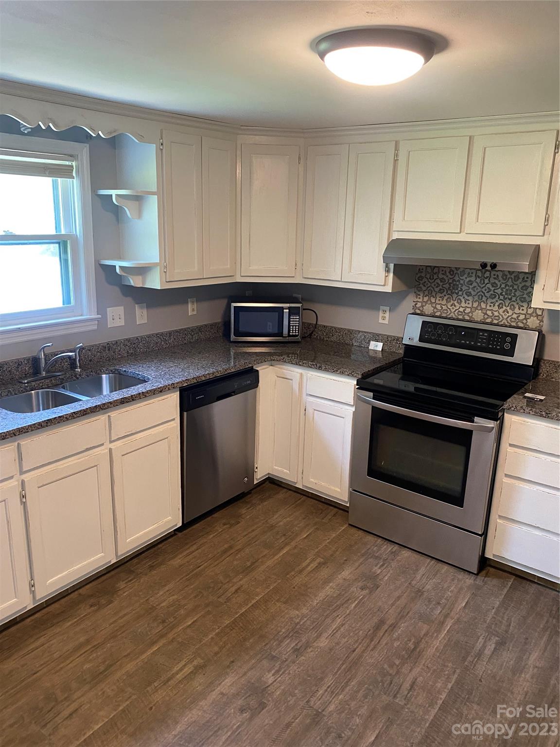 17183 Pond Road Locust, NC 28097 - Photo 5 of 14 a kitchen with sink a microwave and cabinets