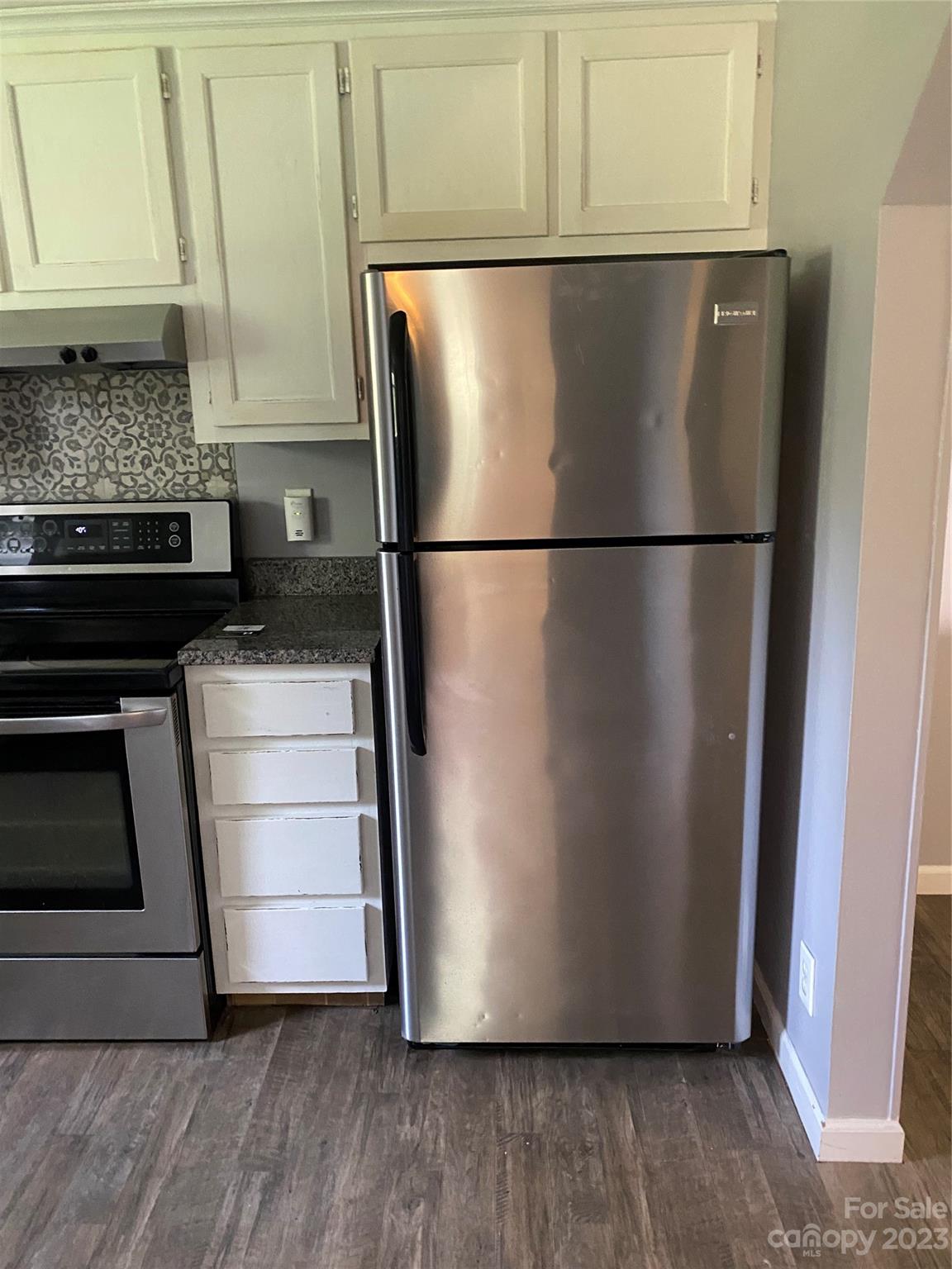 17183 Pond Road Locust, NC 28097 - Photo 6 of 14 a view of a refrigerator in kitchen and an empty room