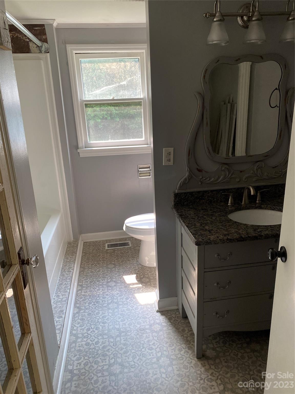17183 Pond Road Locust, NC 28097 - Photo 7 of 14 a bathroom with a granite countertop sink toilet and mirror