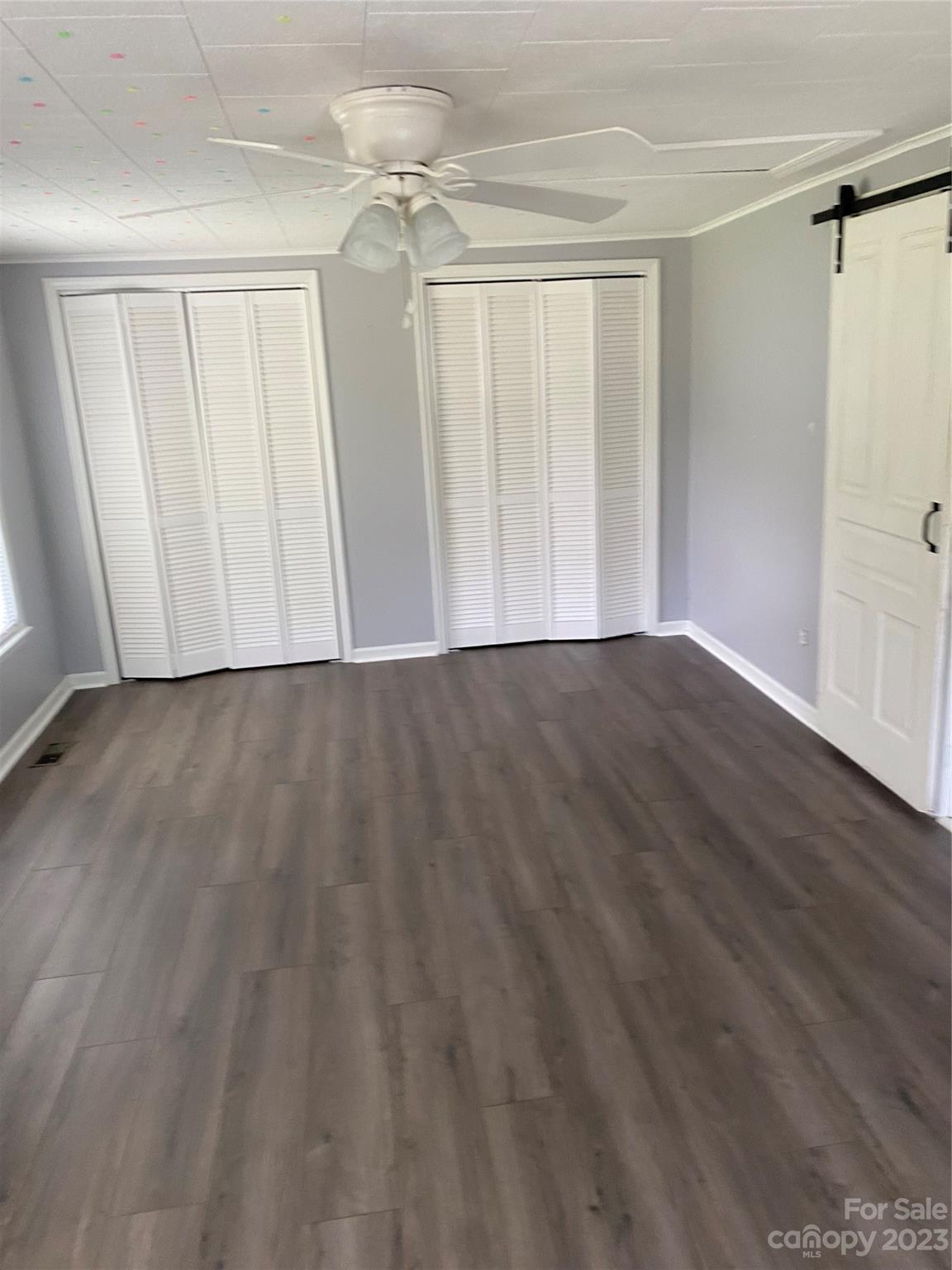 17183 Pond Road Locust, NC 28097 - Photo 10 of 14 a view of an empty room with wooden floor and a window