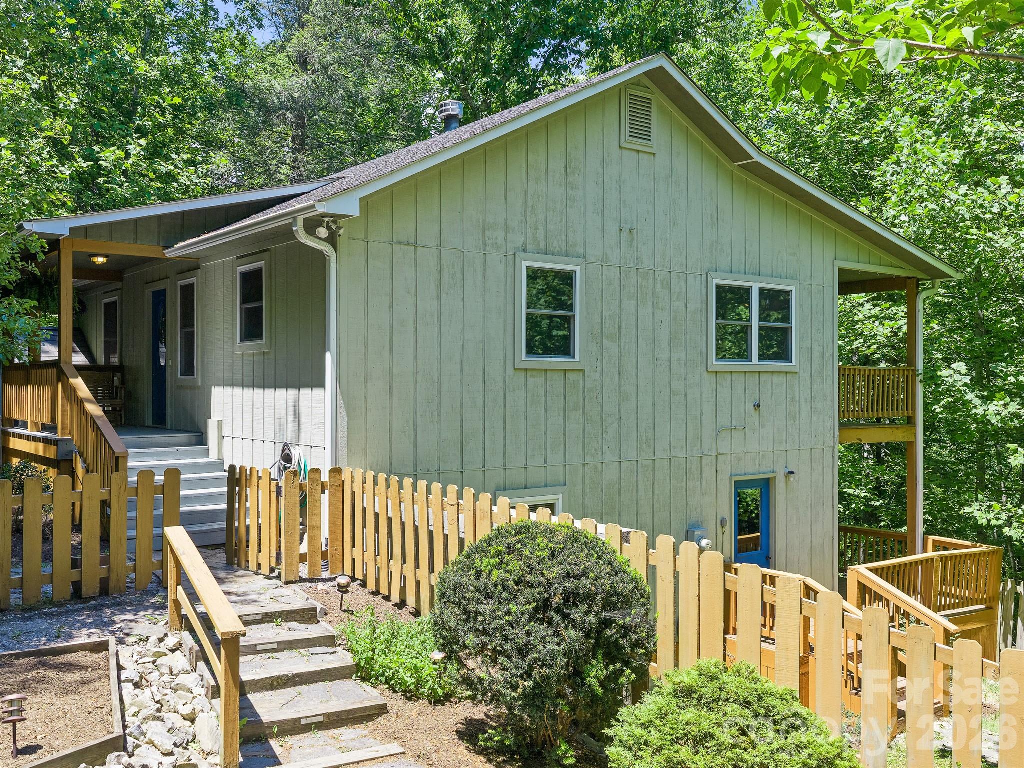 142 Wildflower Road Spruce Pine, NC 28777 - Photo 3 of 46 a front view of a house with wooden fence