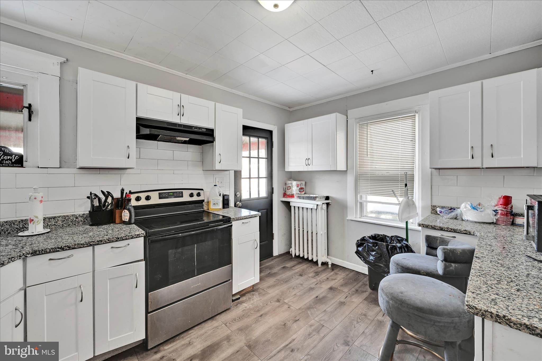 204 East Avon Road Brookhaven, PA 19015 - Photo 12 of 26 a kitchen with sink a stove and cabinets