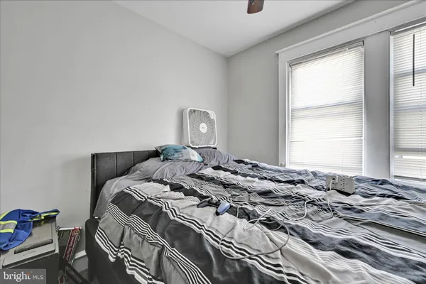 a bed sitting in a bedroom next to a window