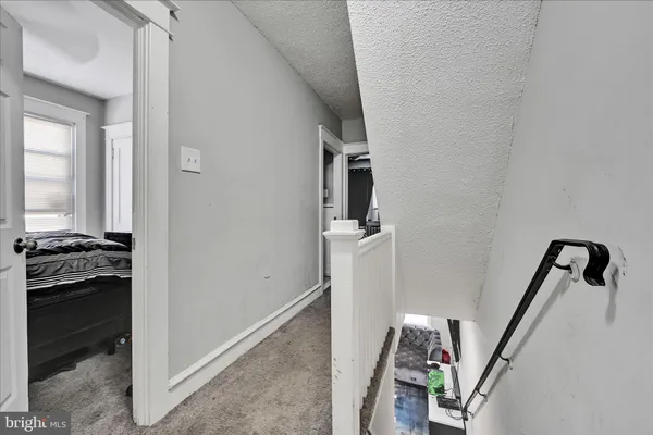 a view of a hallway to a livingroom and a hallway