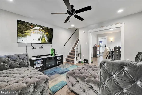 a living room with furniture and wooden floor