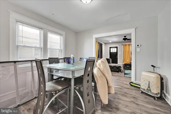 a view of a a dining room with furniture window and wooden floor