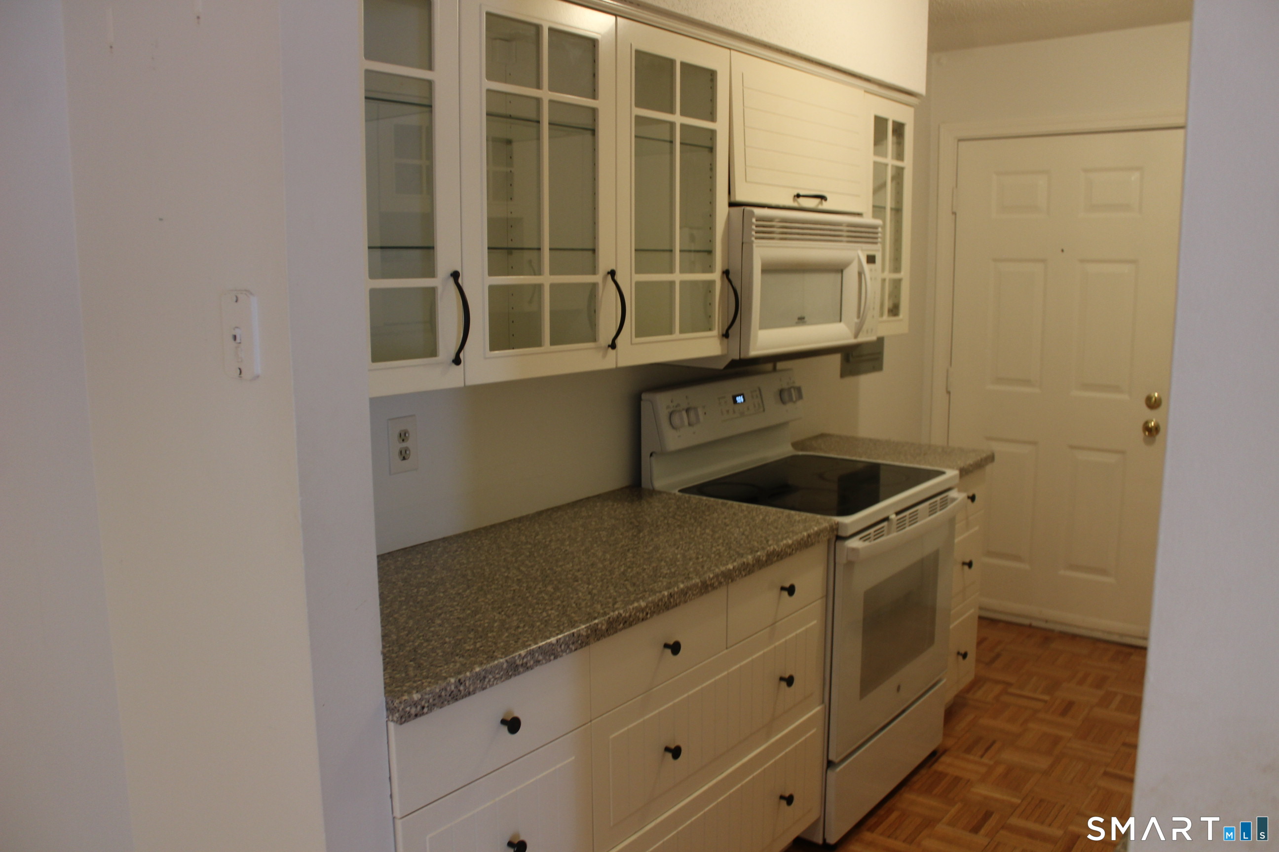 1 Concorde Way, Unit B4 Windsor Locks, CT 06096 - Photo 33 of 40 a kitchen with stainless steel appliances granite countertop a sink and cabinets