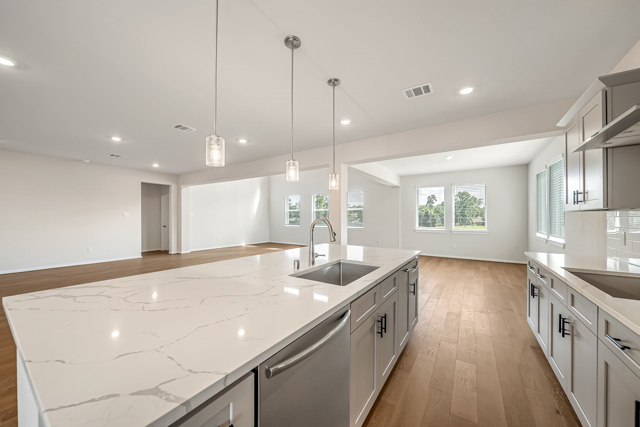 20629 Dynamic Court Humble, TX 77338 - Photo 3 of 26 a view of a kitchen island a sink a counter top space and stainless steel appliances