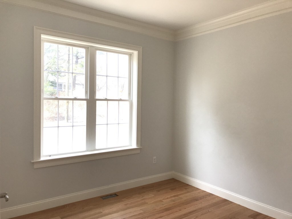 53 Wellesley Rd Extension Natick, MA 01760 - Photo 12 of 27 an empty room with wooden floor and windows