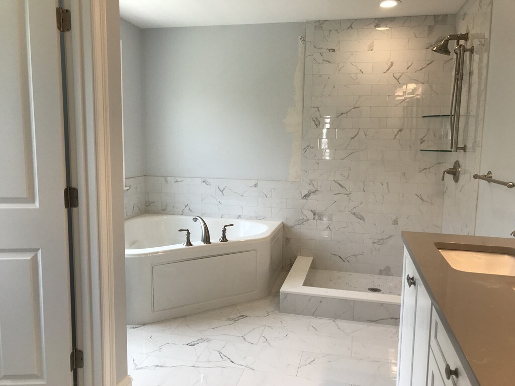 53 Wellesley Rd Extension Natick, MA 01760 - Photo 16 of 27 a bathroom with a bathtub and a shower