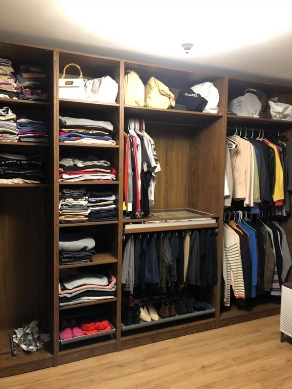 53 Wellesley Rd Extension Natick, MA 01760 - Photo 22 of 27 a view of walk in closet with clothes and shoes