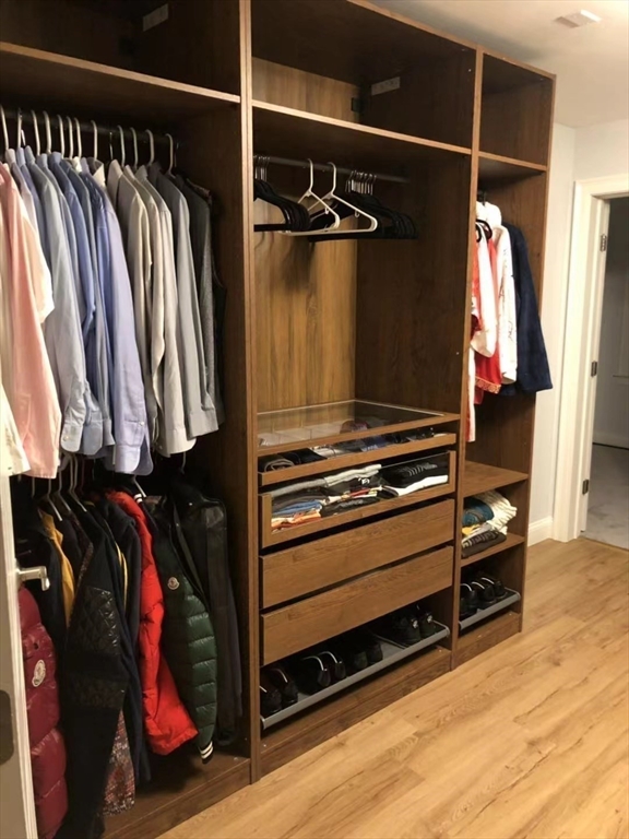 53 Wellesley Rd Extension Natick, MA 01760 - Photo 23 of 27 a view of walk in closet with clothes and shoes