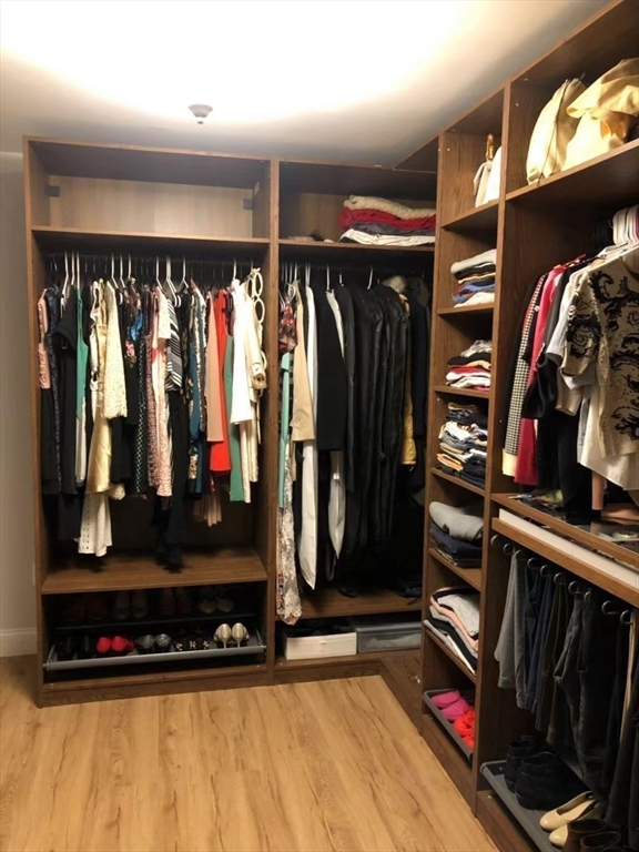 53 Wellesley Rd Extension Natick, MA 01760 - Photo 24 of 27 a view of walk in closet with clothes and shoes