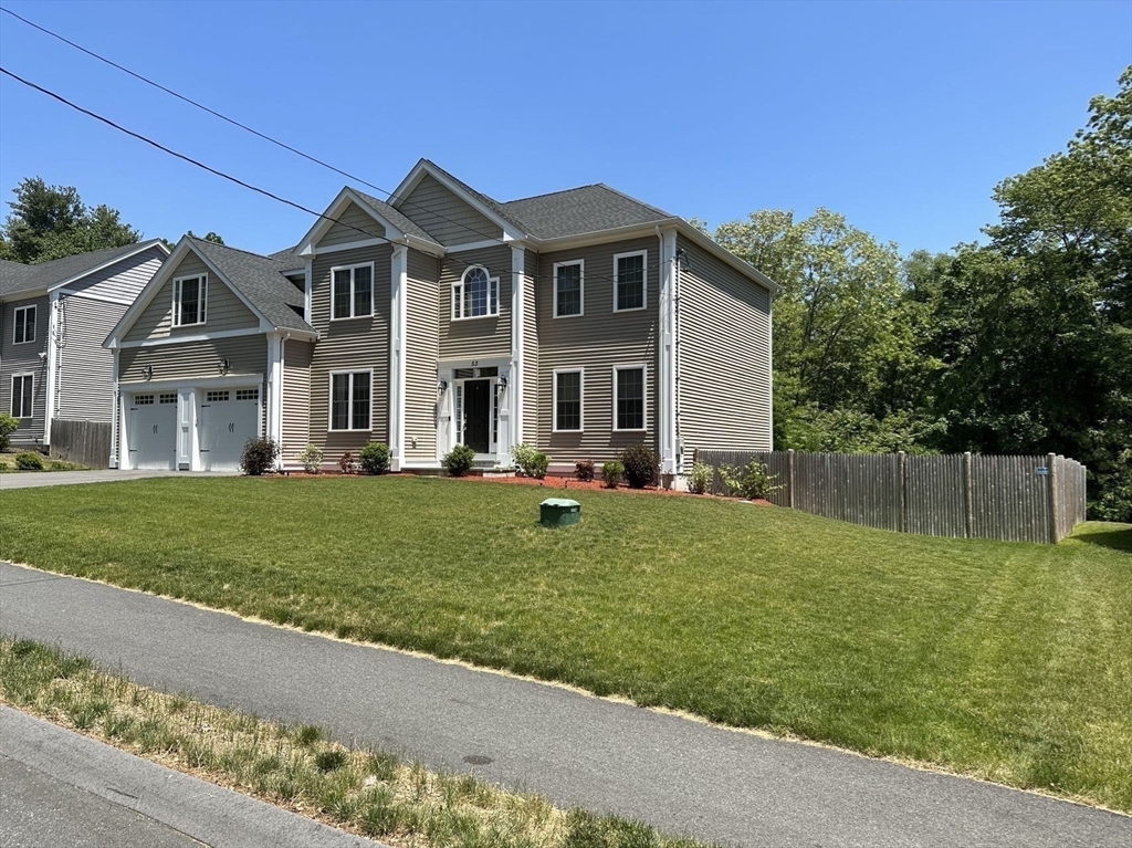 53 Wellesley Rd Extension Natick, MA 01760 - Photo 26 of 27 a front view of a house with a yard