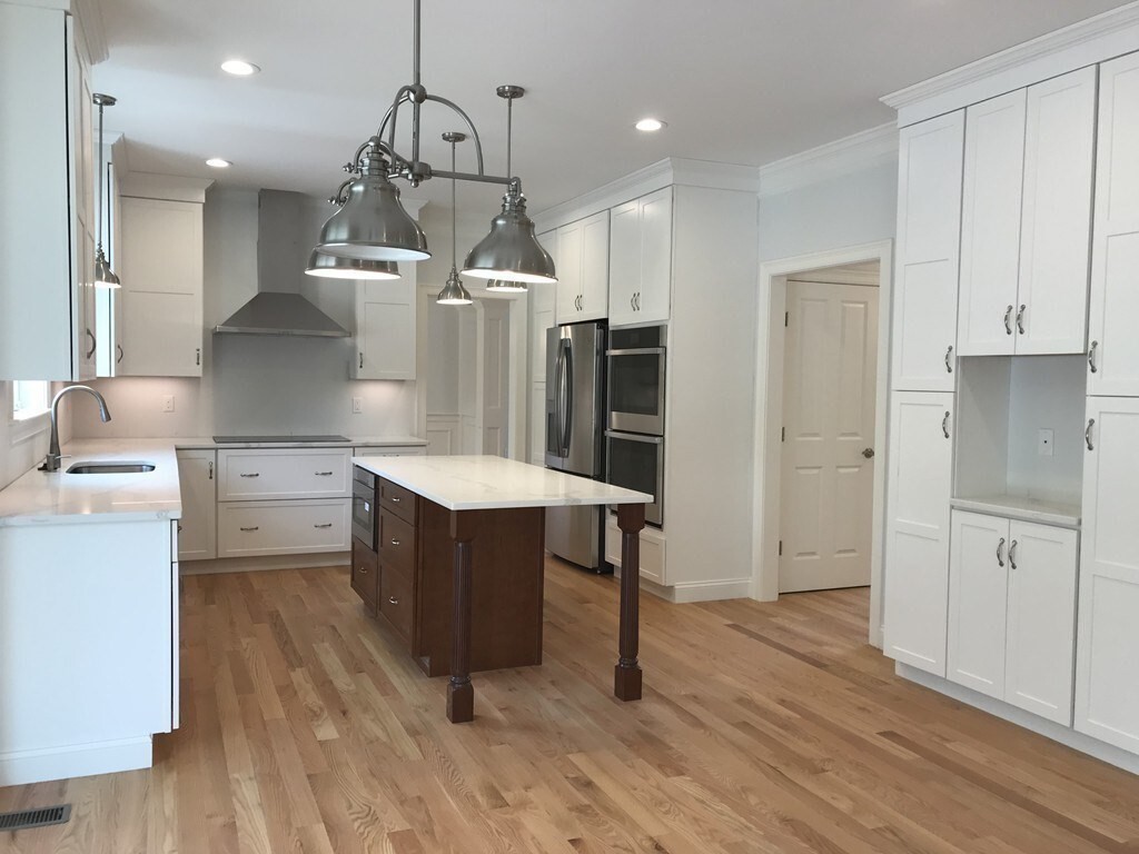 53 Wellesley Rd Extension Natick, MA 01760 - Photo 4 of 27 a kitchen with a refrigerator a sink and wooden floor