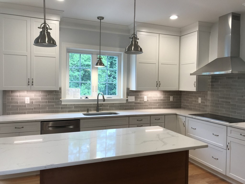 53 Wellesley Rd Extension Natick, MA 01760 - Photo 5 of 27 a kitchen with kitchen island a sink appliances cabinets and a counter top space