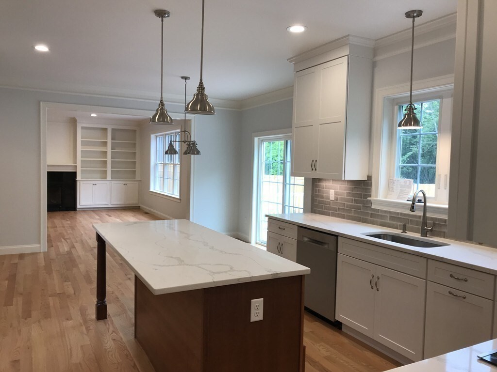 53 Wellesley Rd Extension Natick, MA 01760 - Photo 6 of 27 a kitchen with granite countertop a sink a counter space appliances and cabinets