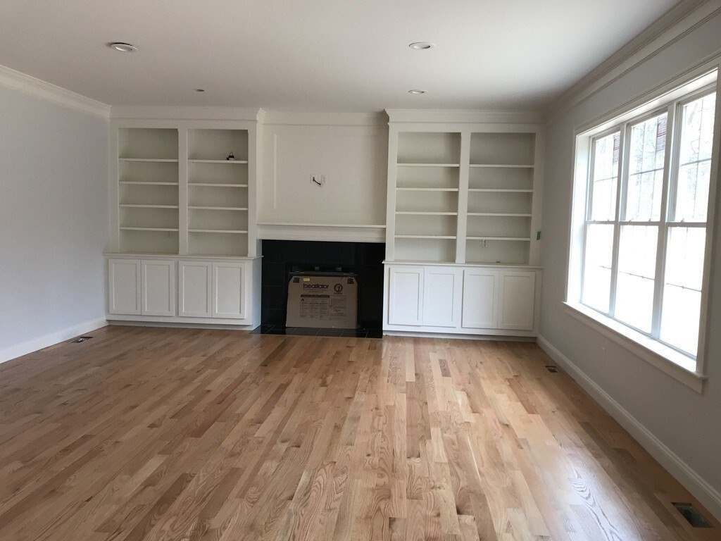 53 Wellesley Rd Extension Natick, MA 01760 - Photo 7 of 27 wooden floor in an empty room with a window