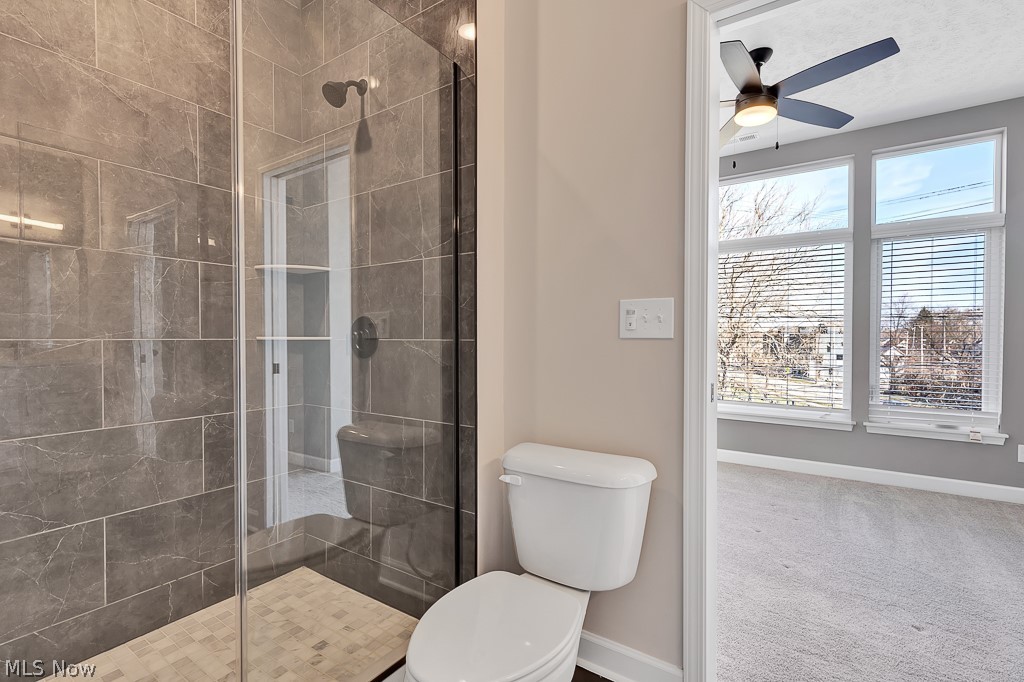 3601 Bailey Avenue Cleveland, OH 44113 - Photo 14 of 22 Bathroom featuring walk in shower, ceiling fan, and toilet