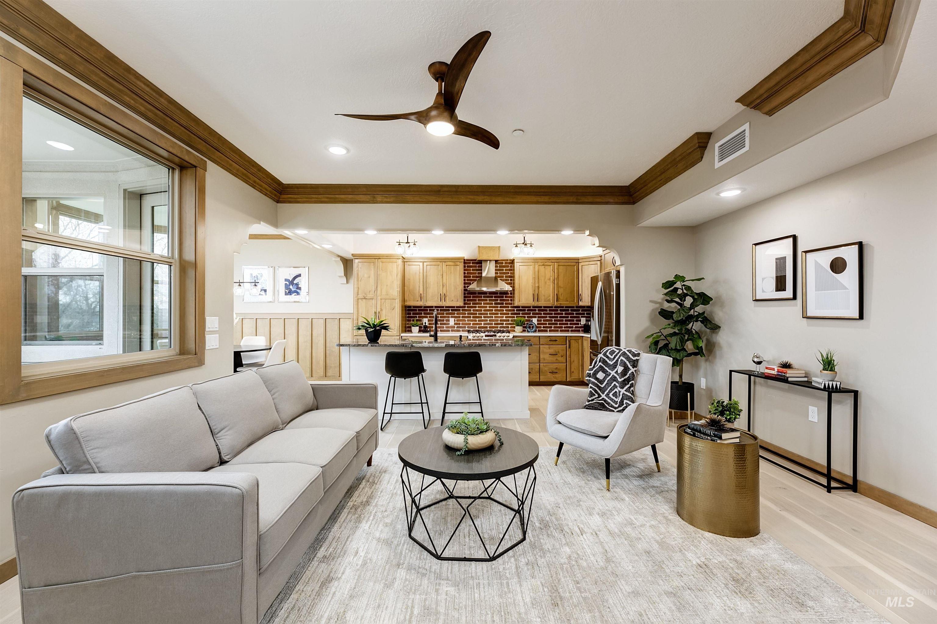 79 West Aikens Road, Unit 203 Eagle, ID 83616 - Photo 13 of 41 Living room with ceiling fan, crown molding, and light wood-type flooring