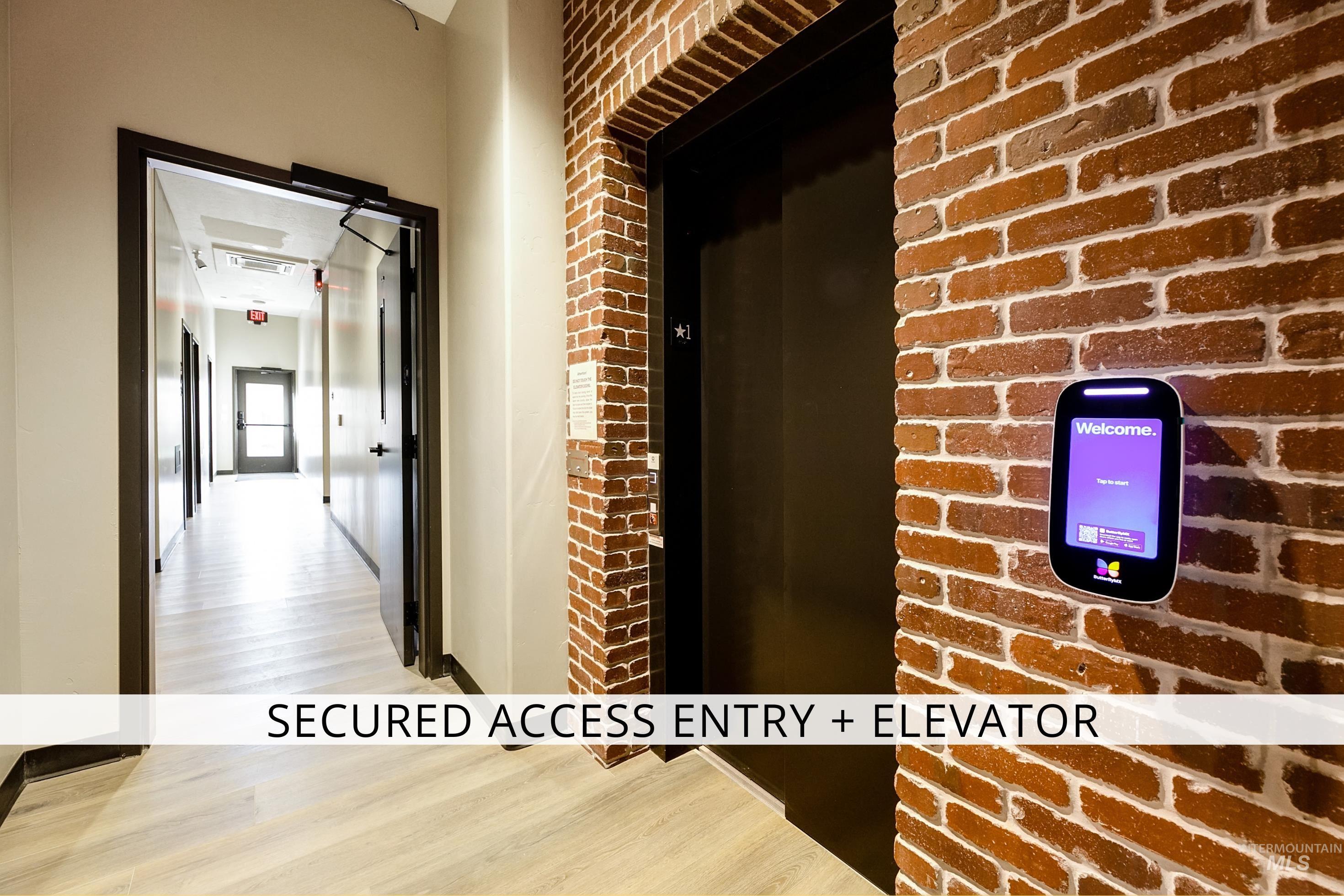 79 West Aikens Road, Unit 203 Eagle, ID 83616 - Photo 3 of 41 Corridor with brick wall and light wood-type flooring