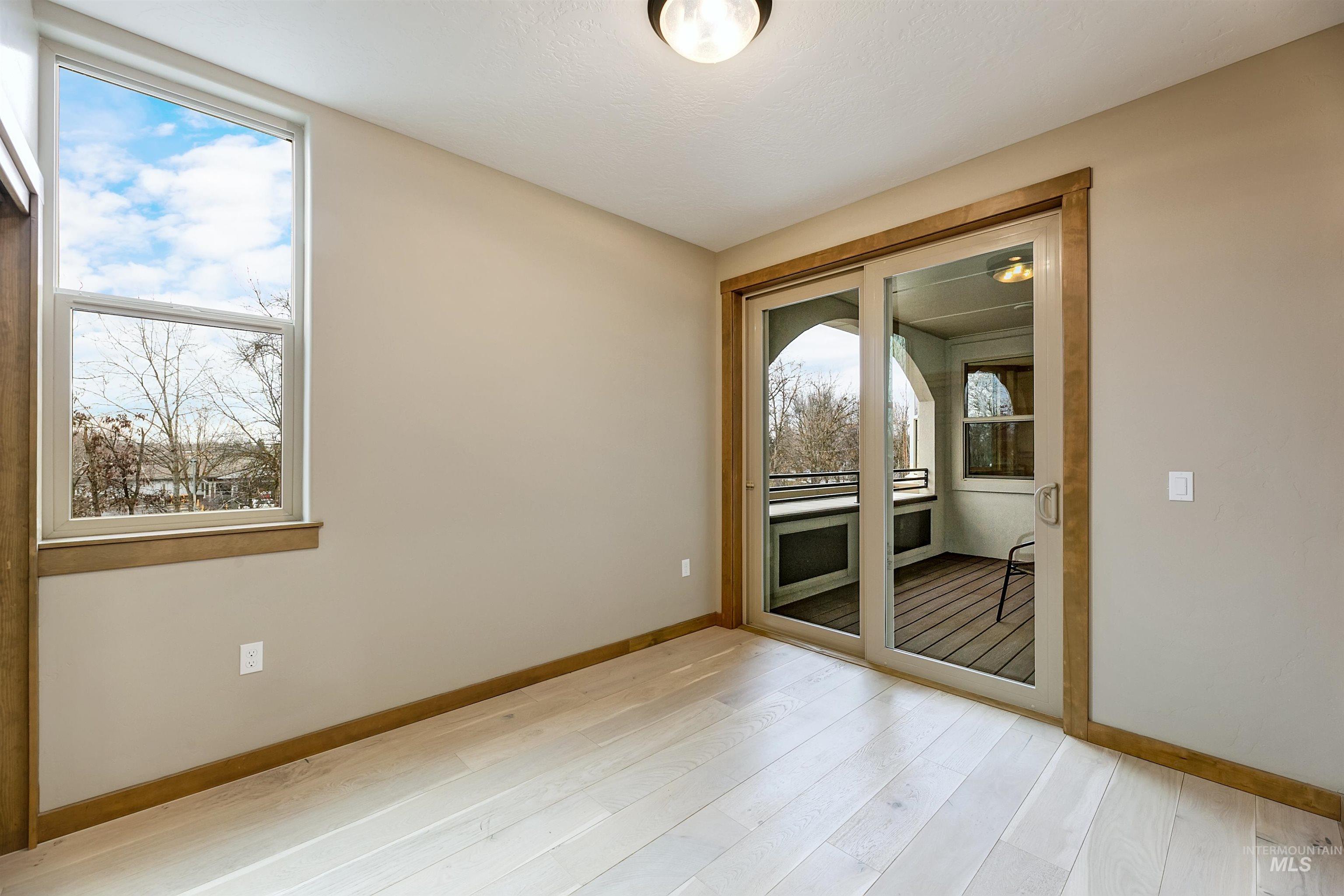 79 West Aikens Road, Unit 203 Eagle, ID 83616 - Photo 38 of 41 Unfurnished room with light wood-style floors and baseboards