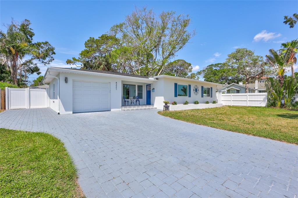 a view of house with outdoor space and swimming pool