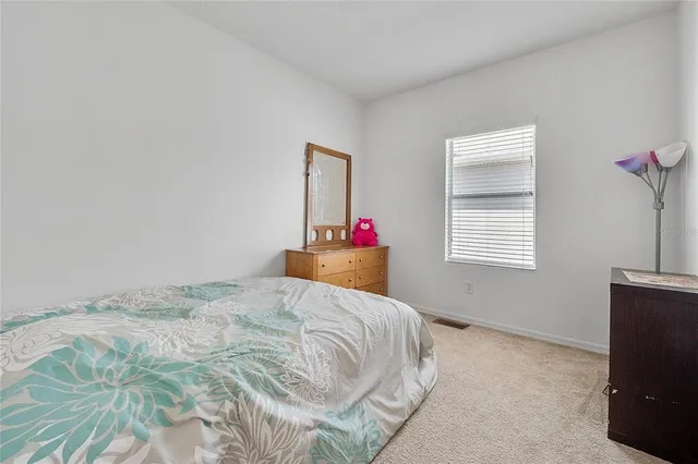 a bedroom with a bed and a tv