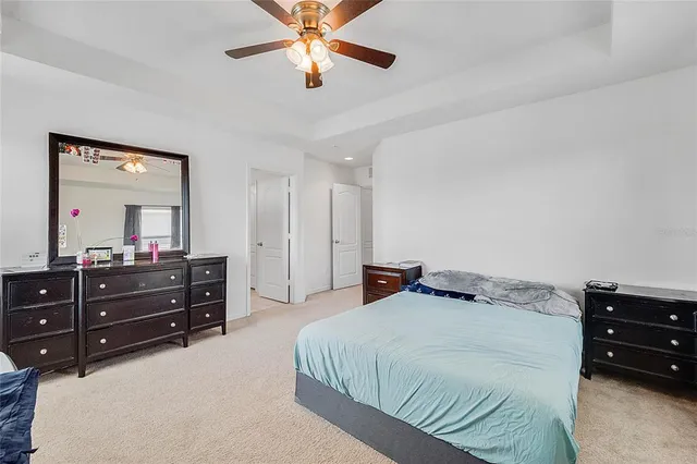 a bedroom with a bed and a mirror on dresser
