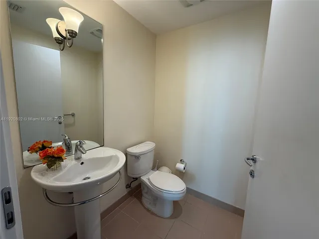 a bathroom with a sink mirror and toilet