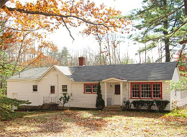 110 Whitney Road Ashby, MA 01431 - Photo 1 of 15 a view of a house with a yard with large tree and wooden fence