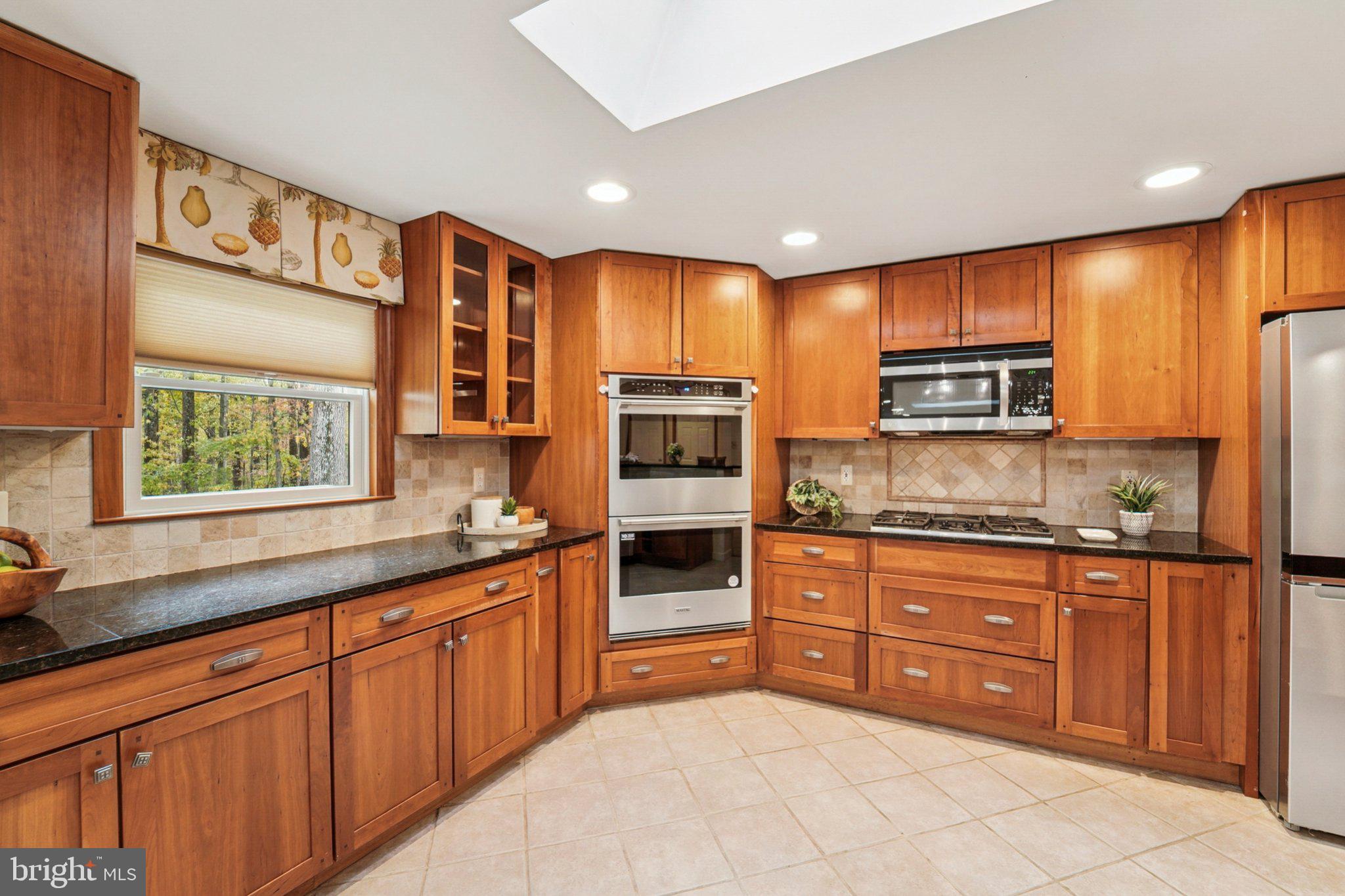 14820 Windmill Terrace Silver Spring, MD 20905 - Photo 14 of 33 a kitchen with stainless steel appliances granite countertop a stove and a sink