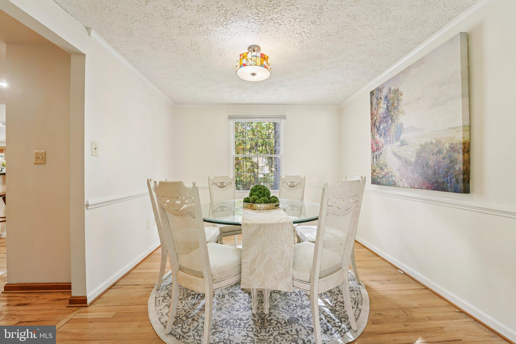 14820 Windmill Terrace Silver Spring, MD 20905 - Photo 15 of 33 a view of a dining room with furniture a chandelier and wooden floor
