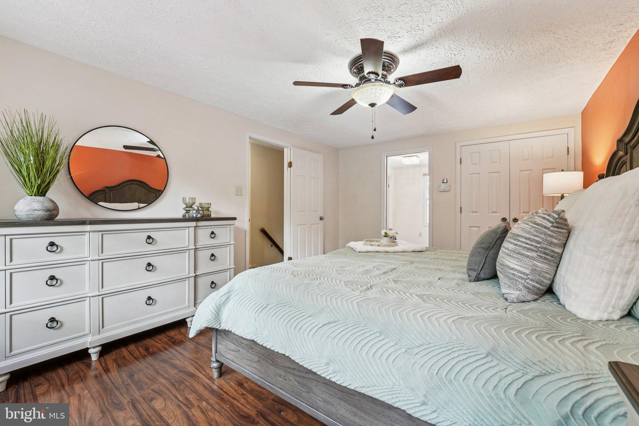 14820 Windmill Terrace Silver Spring, MD 20905 - Photo 18 of 33 a bedroom with a large bed and a chandelier