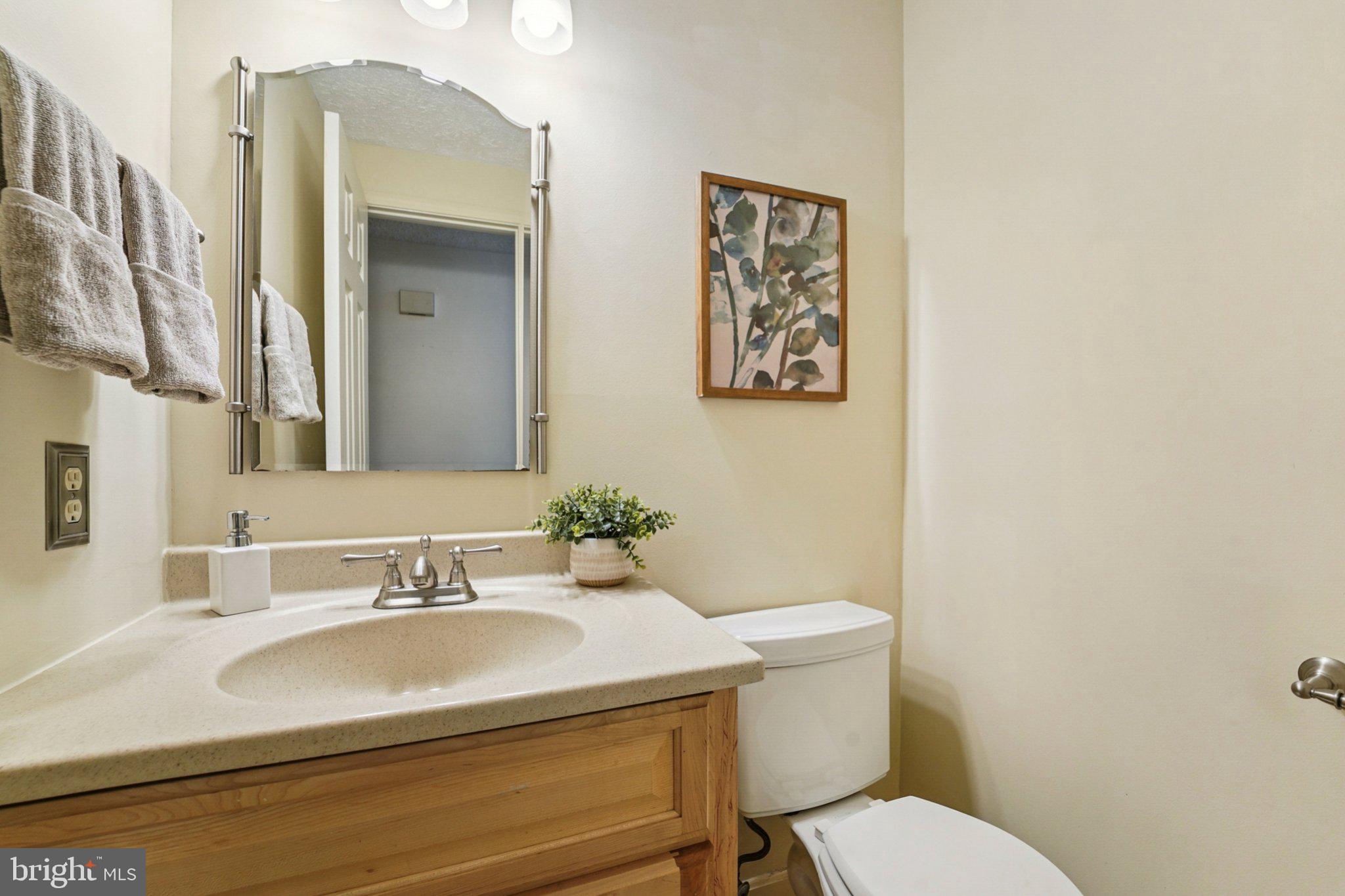 14820 Windmill Terrace Silver Spring, MD 20905 - Photo 19 of 33 a bathroom with a toilet sink and mirror