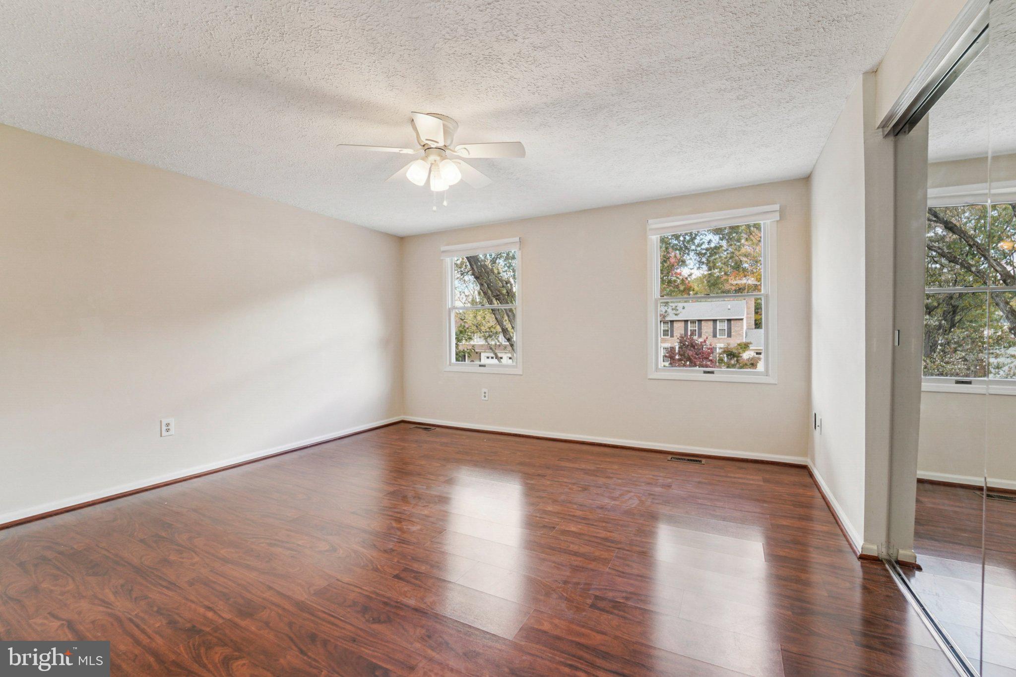 14820 Windmill Terrace Silver Spring, MD 20905 - Photo 22 of 33 a view of an empty room with wooden floor and a window