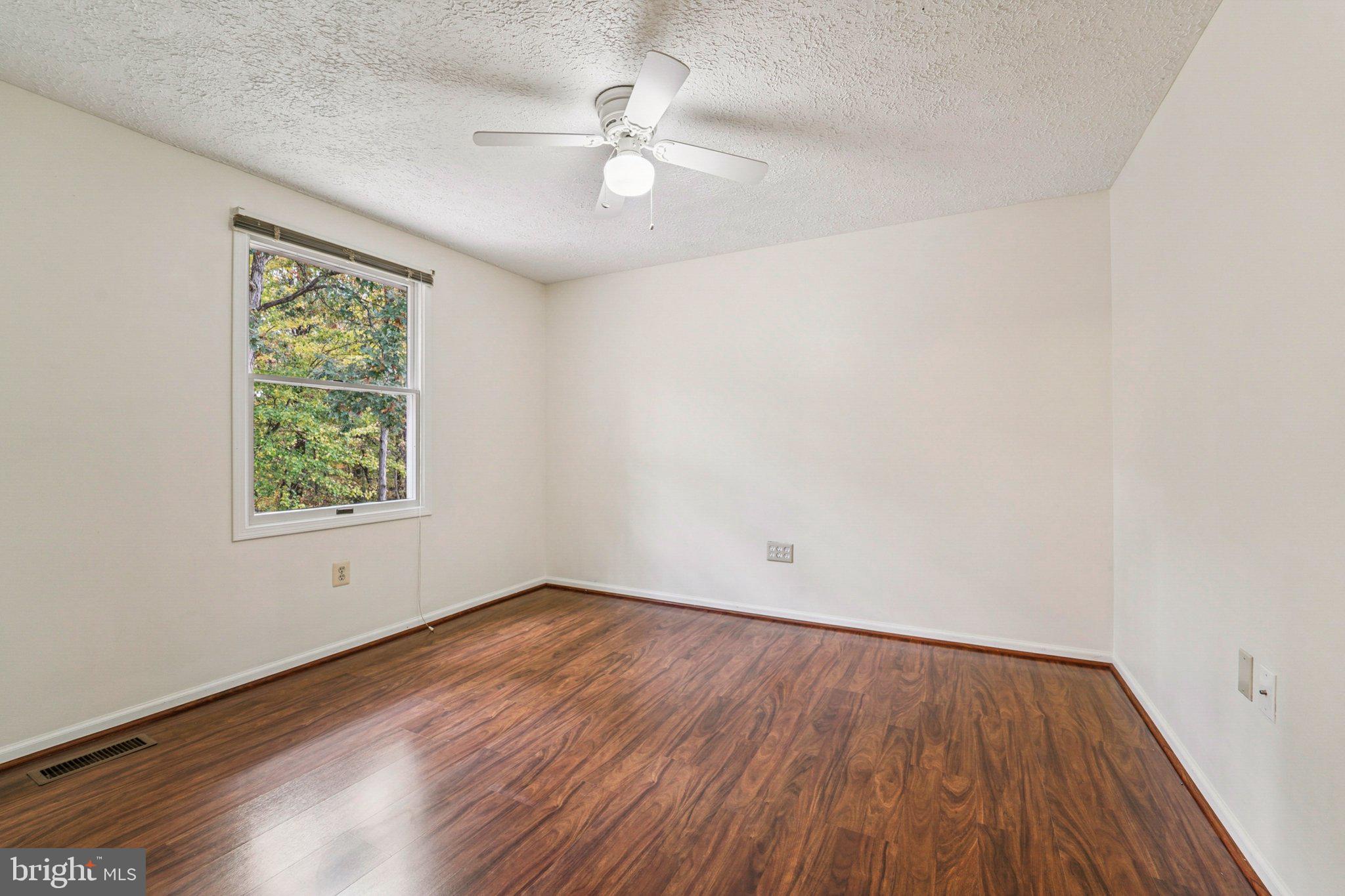 14820 Windmill Terrace Silver Spring, MD 20905 - Photo 24 of 33 wooden floor in an empty room with a window