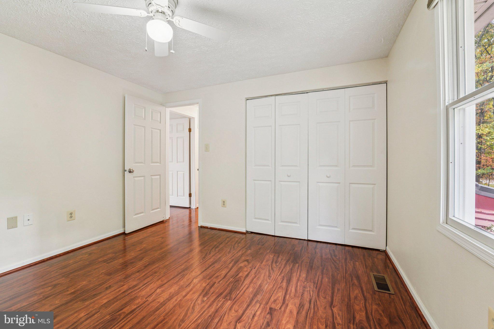 14820 Windmill Terrace Silver Spring, MD 20905 - Photo 25 of 33 an empty room with wooden floor and windows