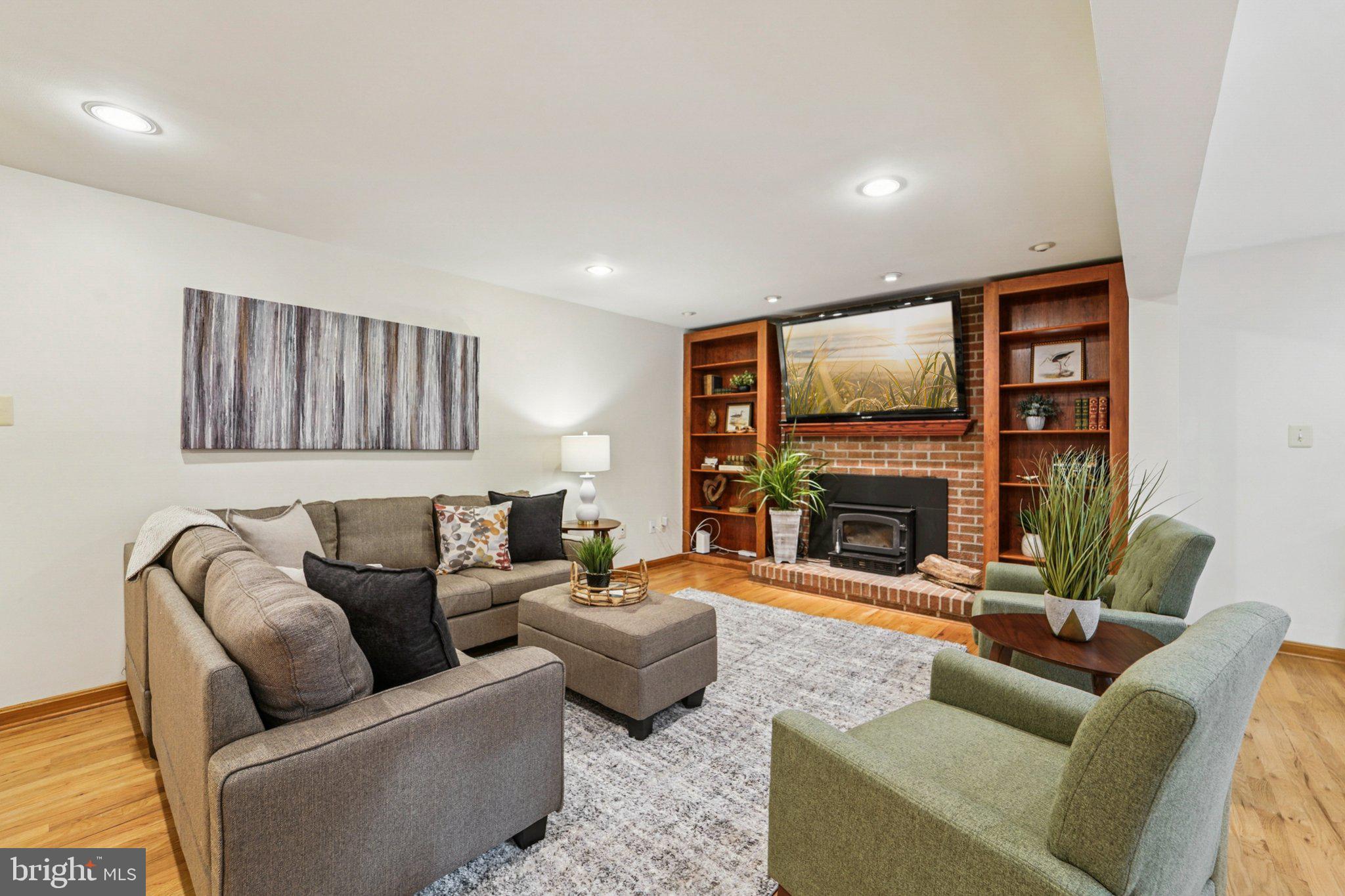 14820 Windmill Terrace Silver Spring, MD 20905 - Photo 9 of 33 a living room with furniture a fireplace and a flat screen tv