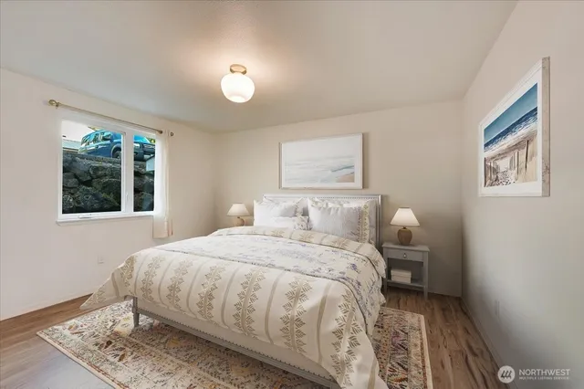 a bedroom with a bed and a painting on the wall