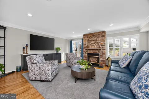 a living room with furniture fireplace and flat screen tv