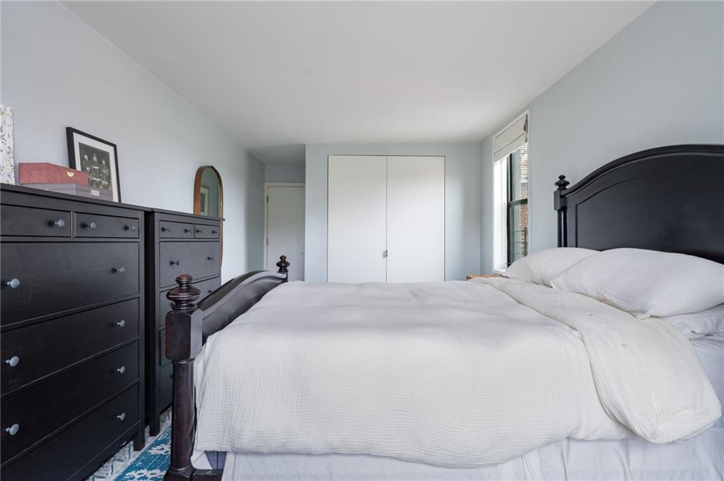 515 East 7th Street, Unit 5H Brooklyn, NY 11218 - Photo 11 of 17 a bed sitting in a bedroom and dresser