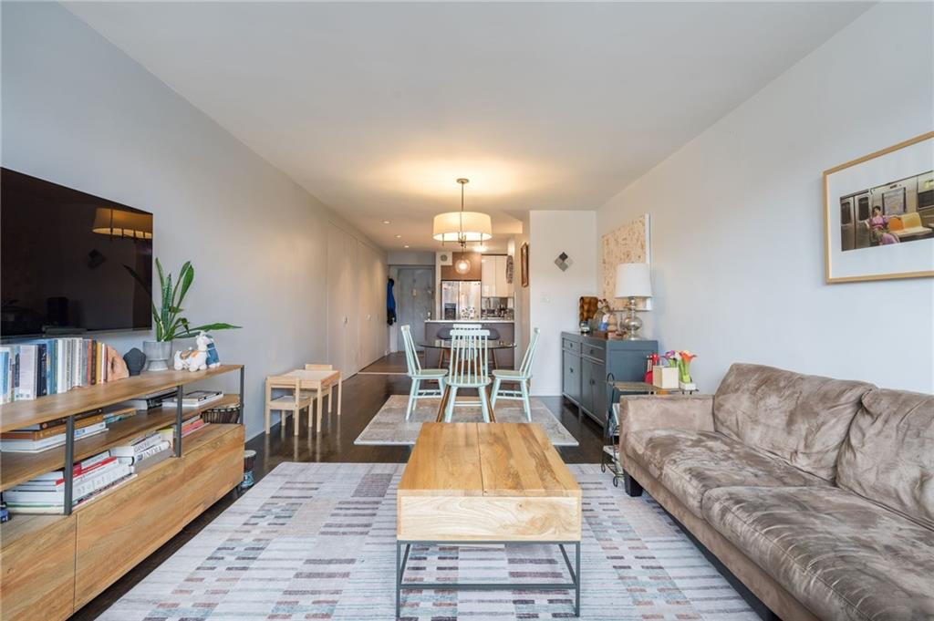 515 East 7th Street, Unit 5H Brooklyn, NY 11218 - Photo 2 of 17 a living room with furniture and a flat screen tv