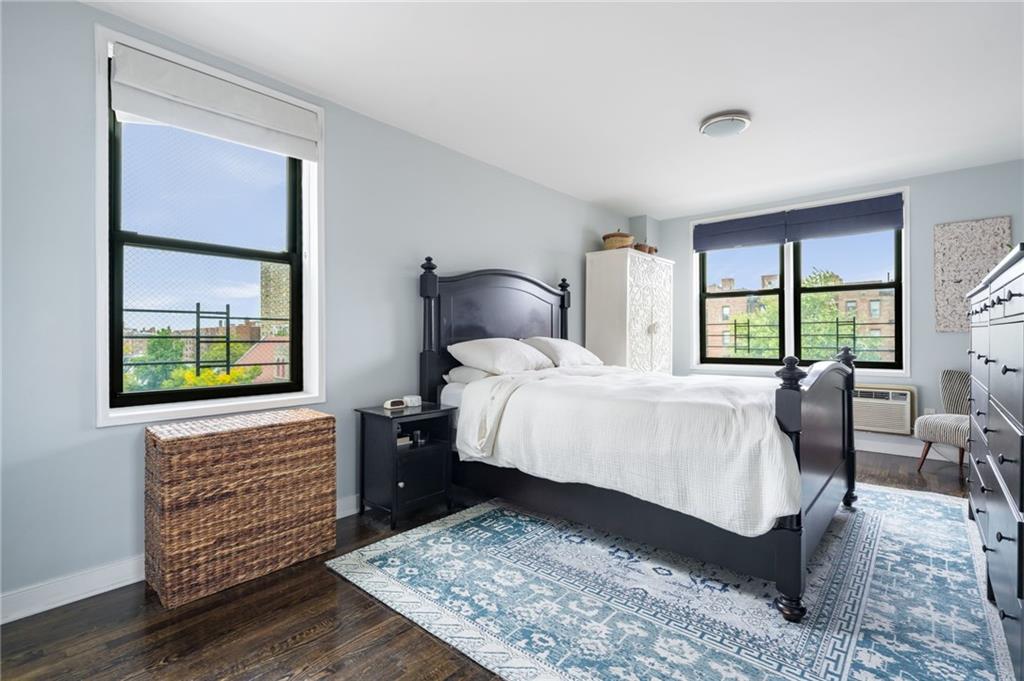 515 East 7th Street, Unit 5H Brooklyn, NY 11218 - Photo 9 of 17 a bedroom with a bed a dresser next to a window