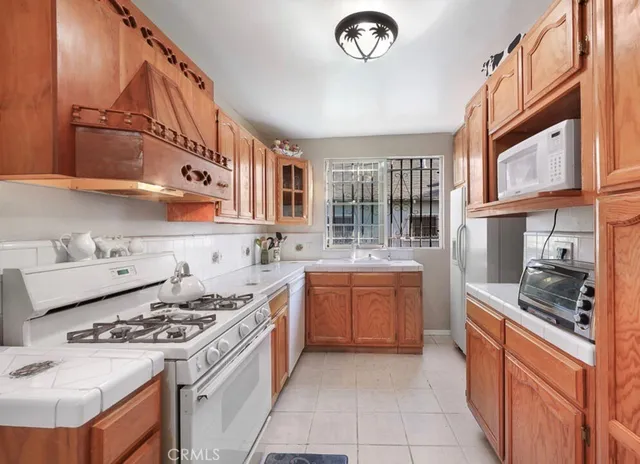 a kitchen with stainless steel appliances granite countertop a stove and a sink