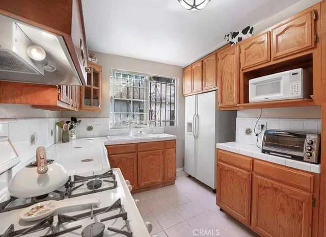 a kitchen with stainless steel appliances a sink stove and refrigerator