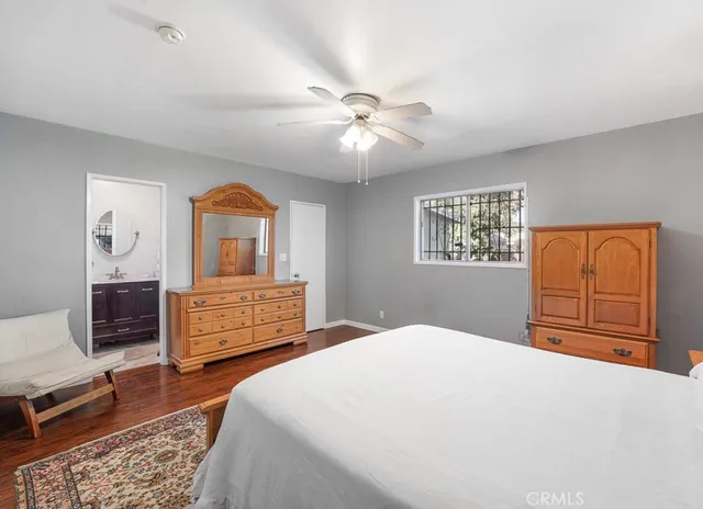 a bedroom with a large bed a dresser and chair