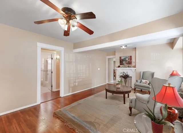 a living room with furniture and a ceiling fan