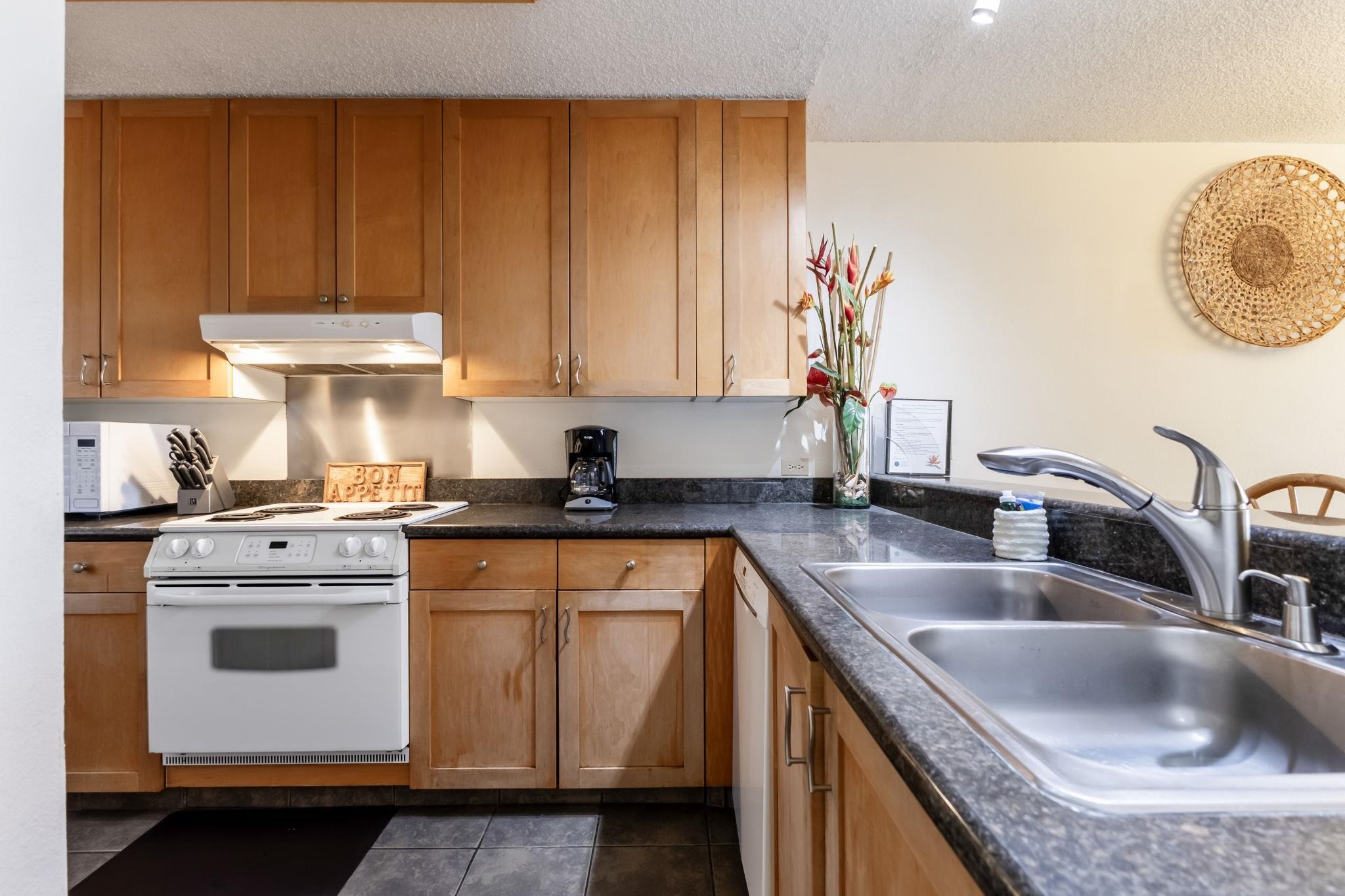 2695 South Kihei Road, Unit 4301 Kihei, HI 96753 - Photo 12 of 45 a kitchen with a sink stove and cabinets