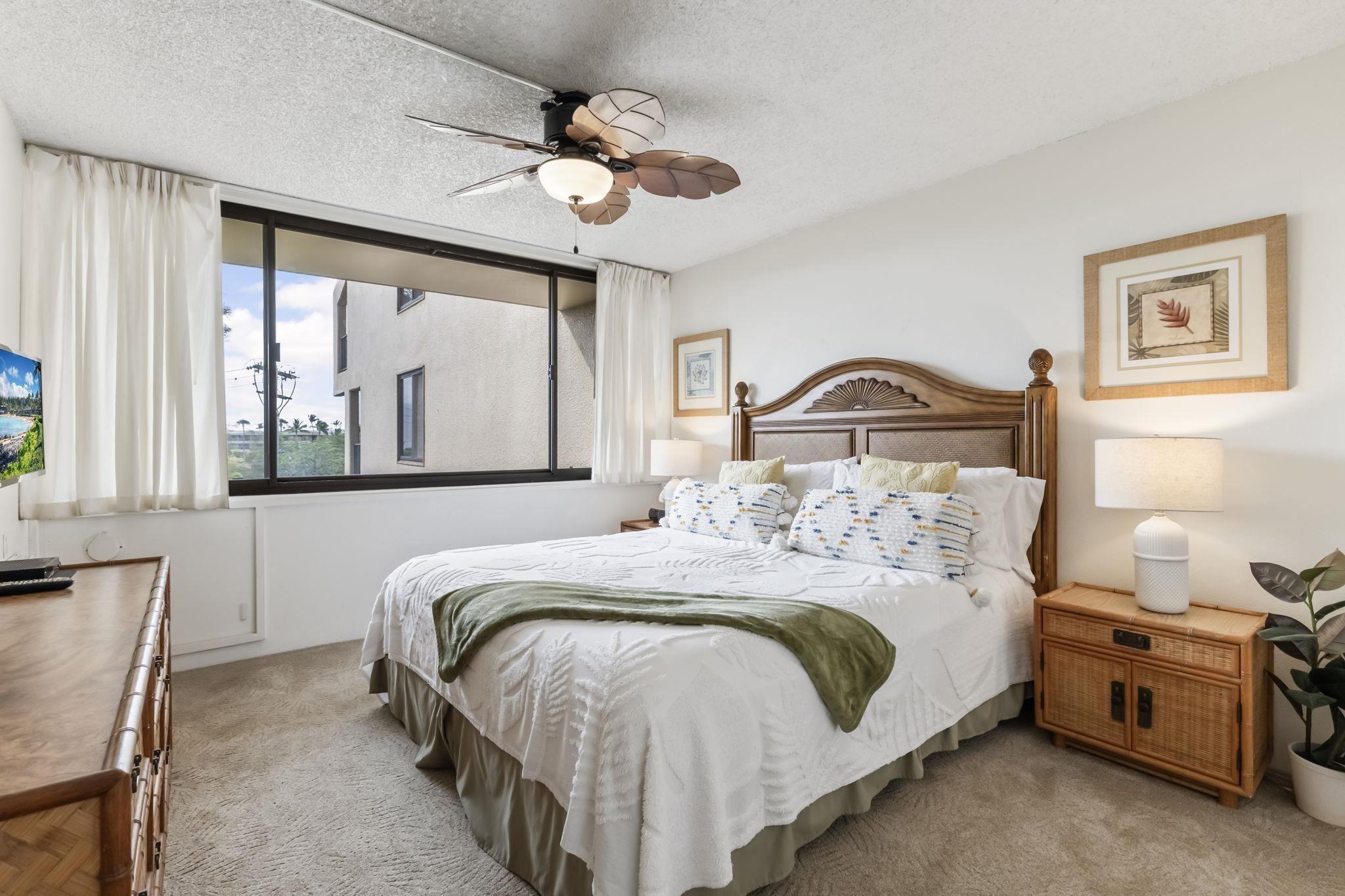 2695 South Kihei Road, Unit 4301 Kihei, HI 96753 - Photo 14 of 45 a bedroom with a bed and a large window